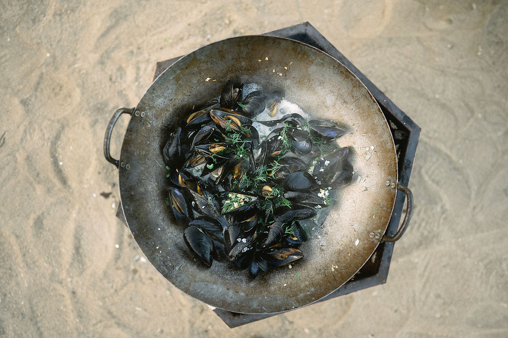 fresh oysters slowly cooking on the fire